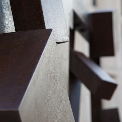 A brown rectangular sculpture cocked at an angle