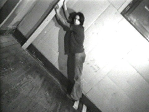 Rita Myers, Tilt 1, 1973 A woman leaning at an scute angle on a wooden floor