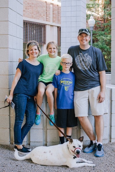 family in front of sculpture