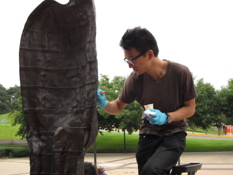 student waxing bronze sculpture