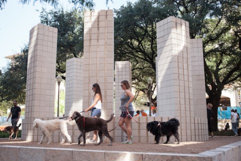 Sol LeWitt structure with people walking dogs
