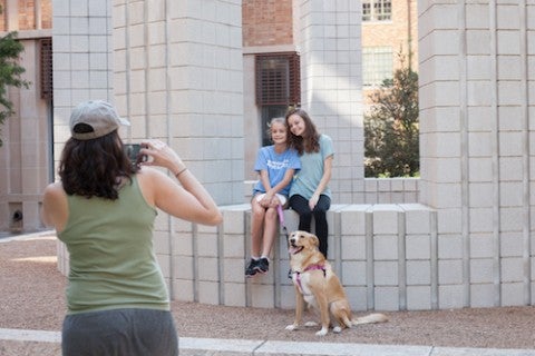 family taking photo in front of sculpture