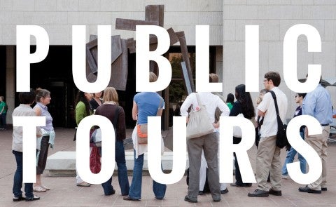 People standing in front of a sculpture