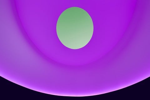 A photo of the Skyspace with the sky appearing green and the walls appearing purple/pink