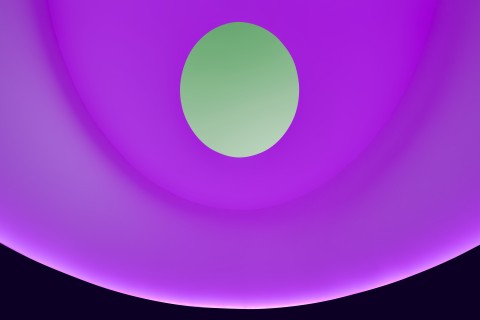 An image of the interior of James Turrell's skyspace with purple/pink color lighting the walls, turning the visible sky green through the oculus. 