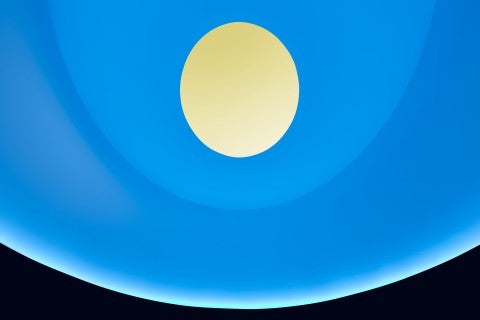 A image of the light sequence inside "The Color Inside." The room appears blue, causing the sky seen through the oculus to appear yellow.