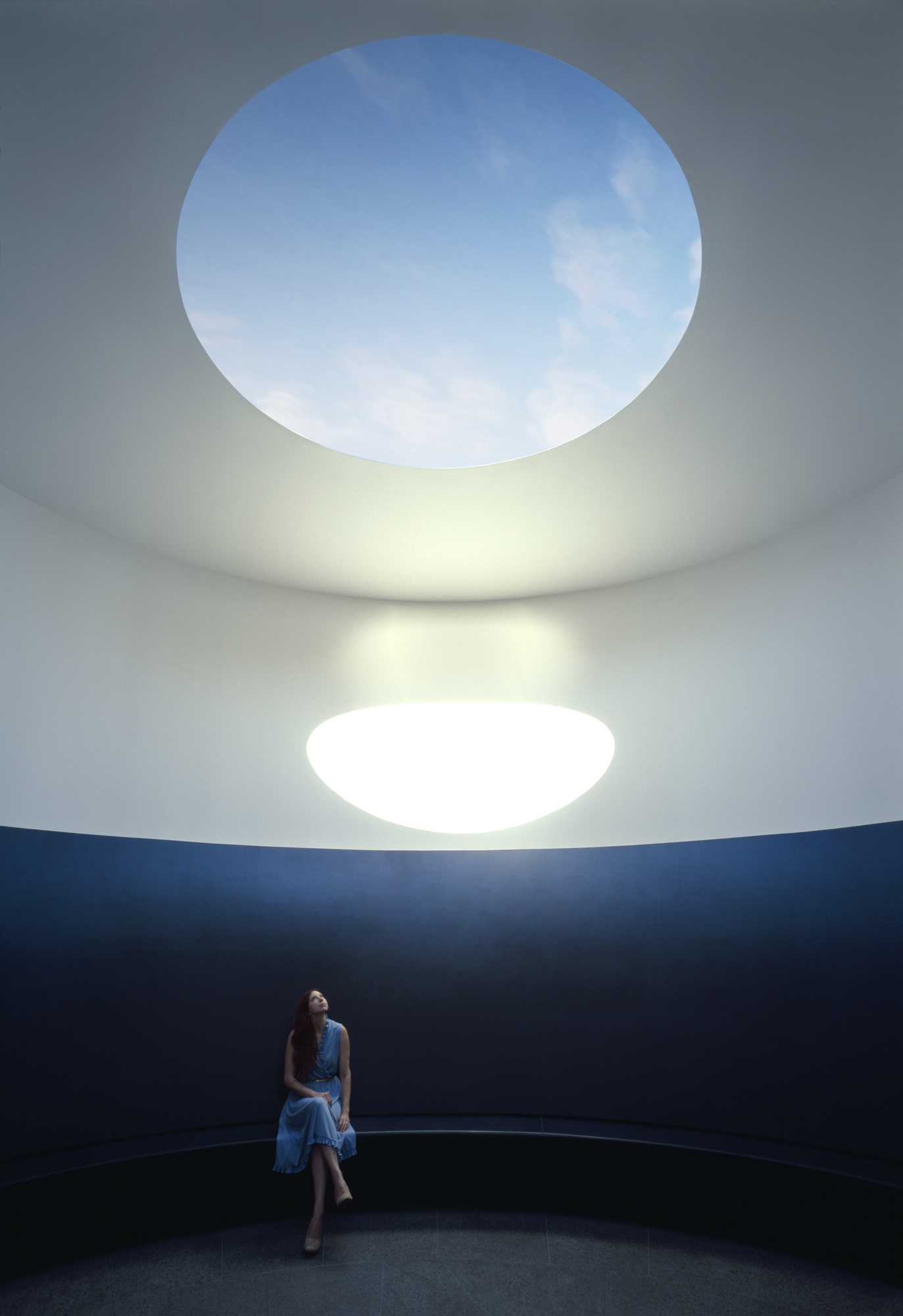 A woman sits in James Turrell's Skyspace, 